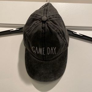 Black/Dark Grey adjustable Hat. Game Day on the front. Never worn